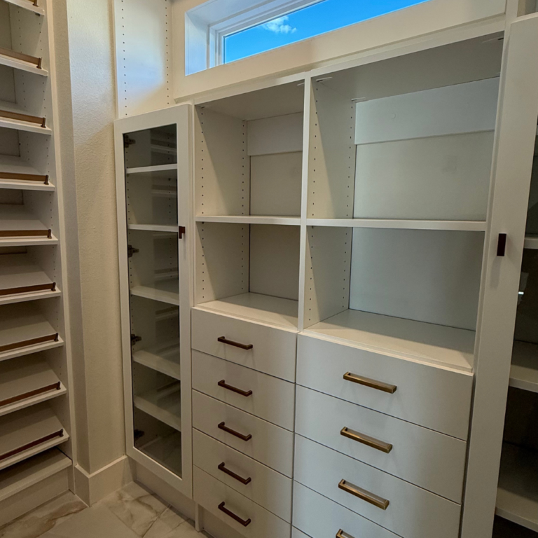 Dressing room with glass-door cabinets and a drawer wall – photo 1